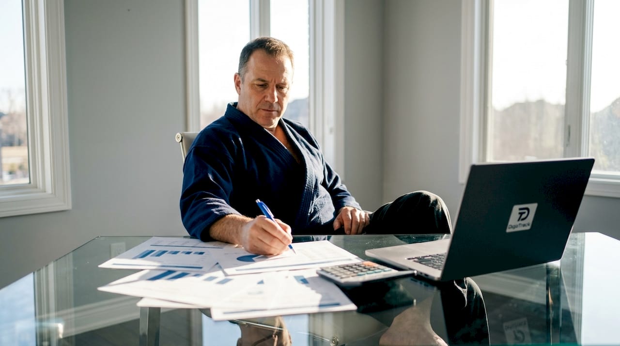 Martial arts school owner reviewing financial reports