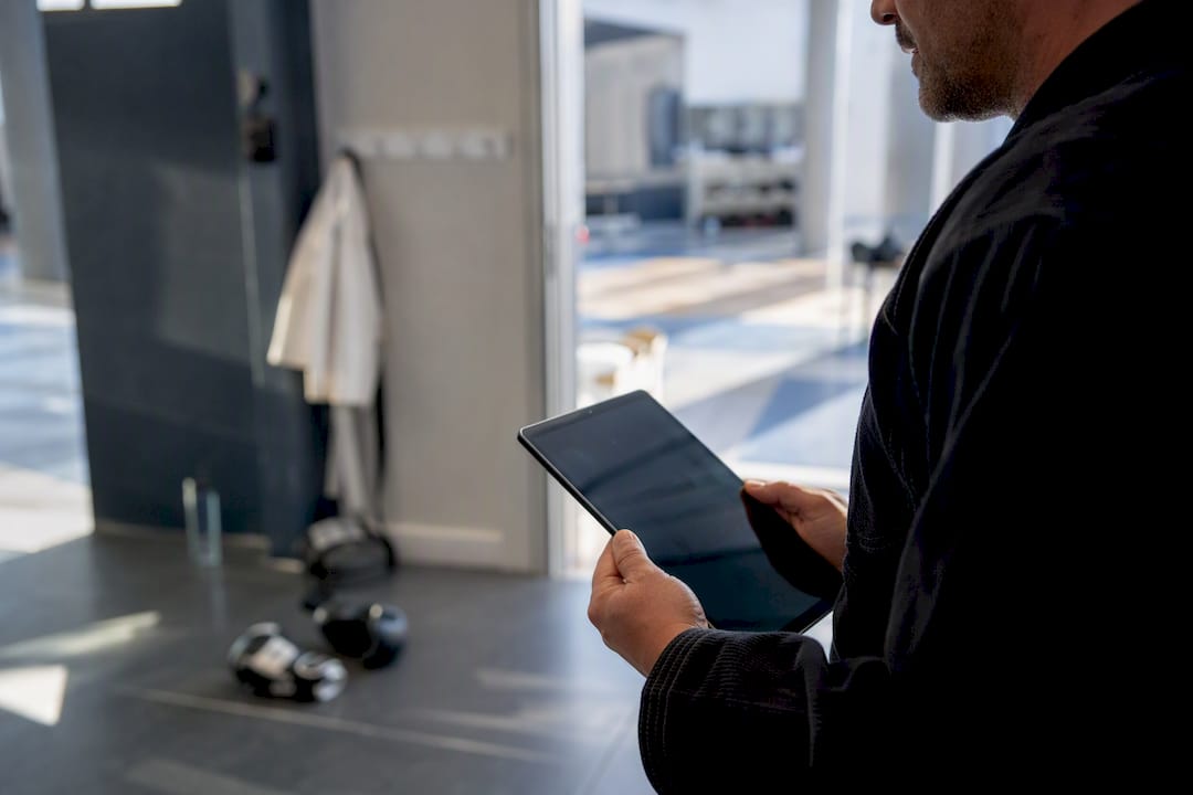 Dojo owner holding tablet at entrance