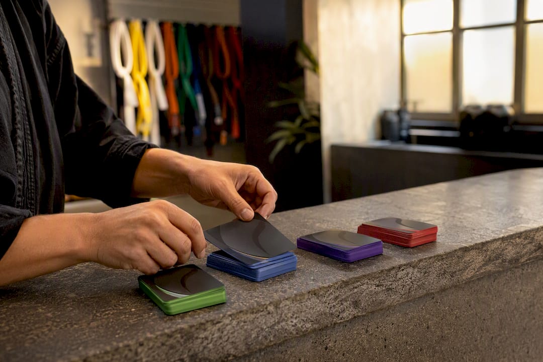 Hands sorting tiered membership cards