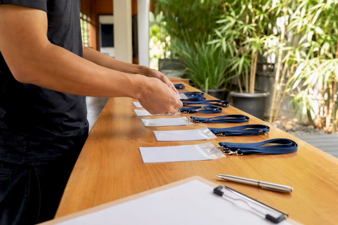 Hands preparing seminar registration materials