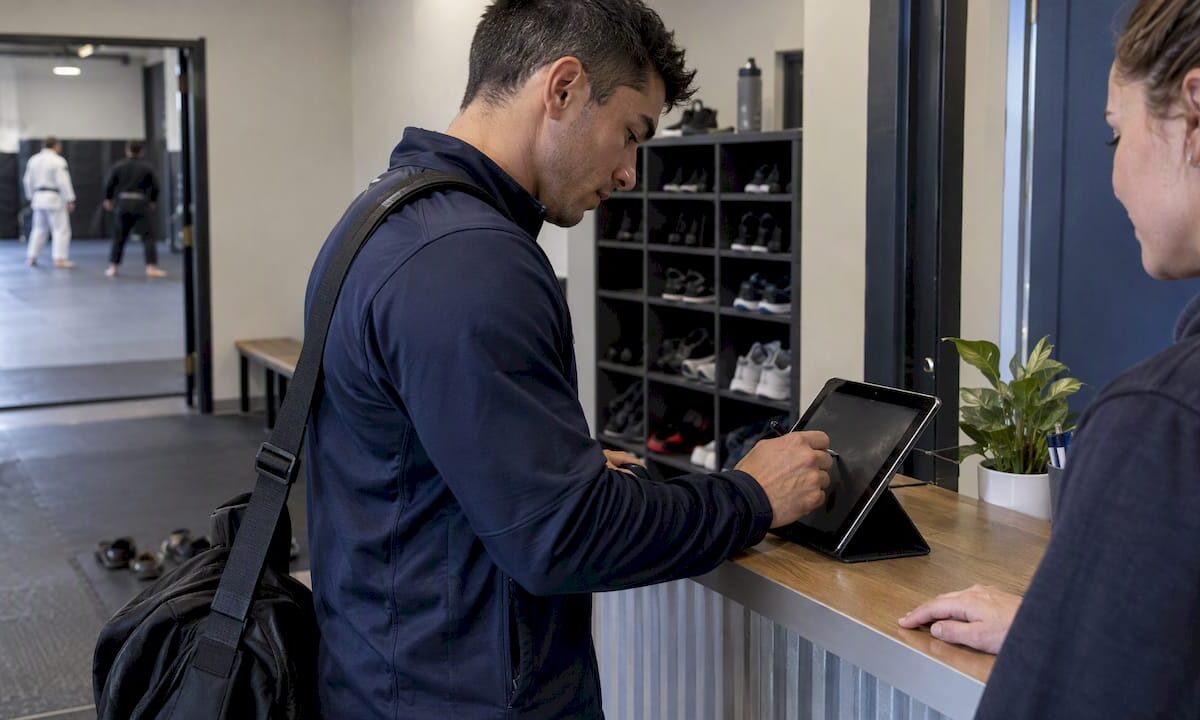 Student signing digital waiver at dojo kiosk